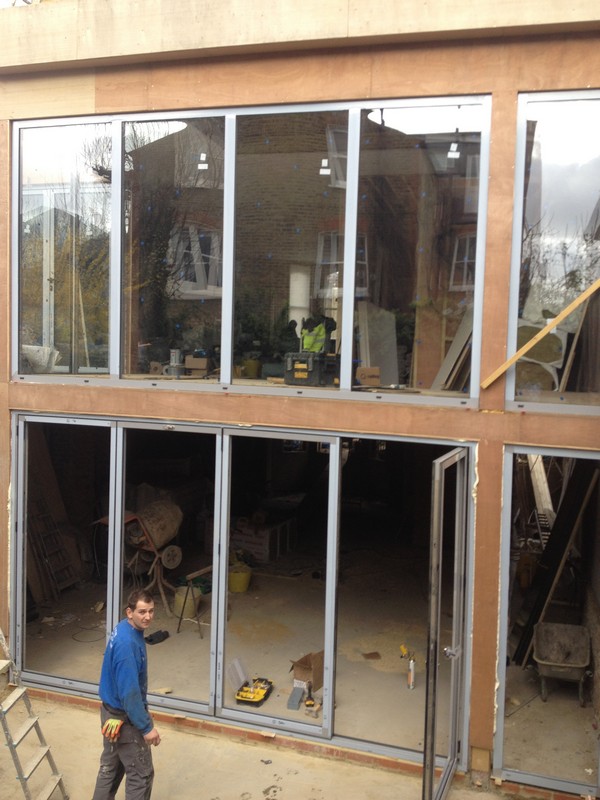 Aluminium bi-fold doors with two-storey glazing in Brentford