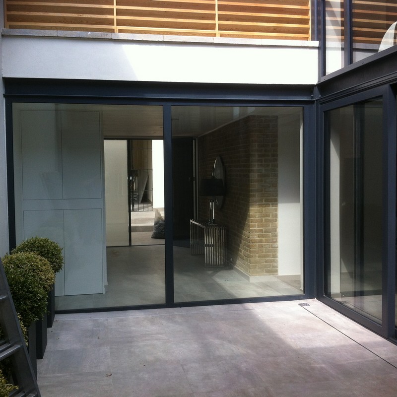 Floor-to-ceiling sliding doors opening to courtyard in Brentford