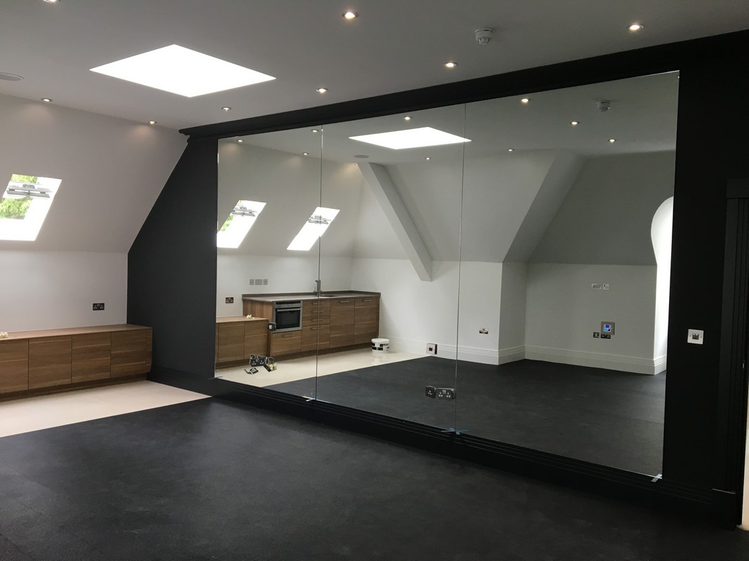 Frameless glass wall dividing loft conversion in Brentford