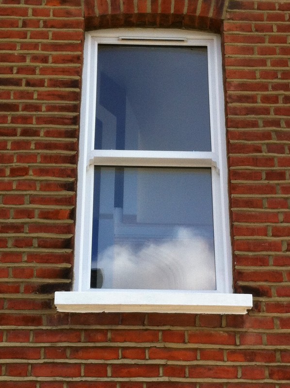 uPVC sash window on Victorian red brick house in Brentford